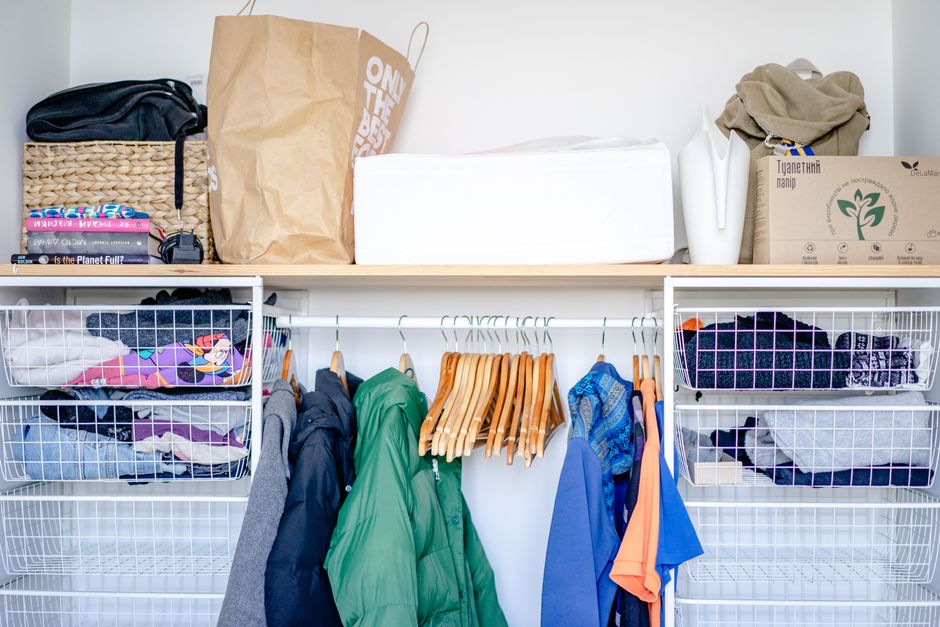 Folded clothes neatly arranged on a high-quality wooden closet shelf