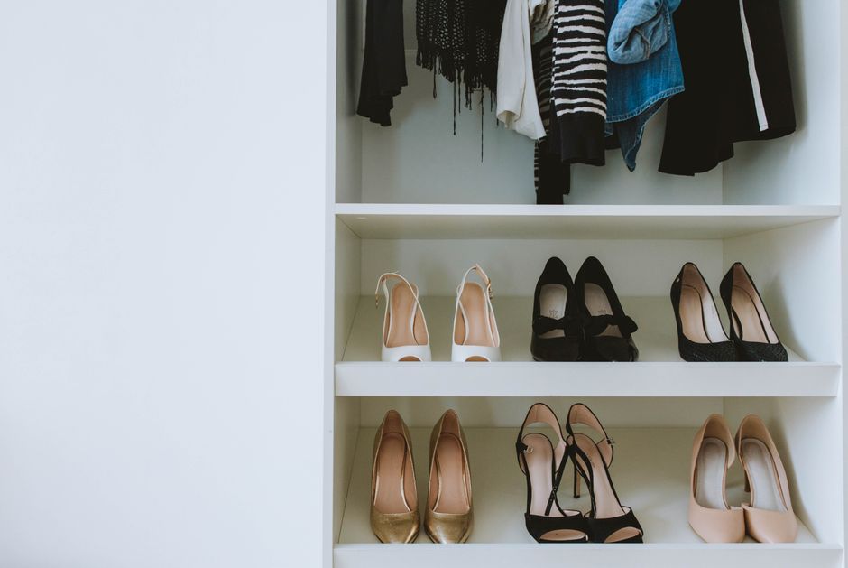 A highly organized shoe rack displaying various styles in a custom wardrobe